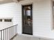 Modern front door with glass inserts, complemented by white siding and a dark-colored finish at 108 Bearwallow Forest Way, Wendell, NC 27591