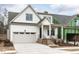 Charming two-story home with a brick-lined front porch and attached two-car garage at 108 Bearwallow Forest Way, Wendell, NC 27591