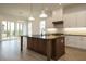 Modern kitchen with white cabinets, large island, and stainless steel appliances at 108 Bearwallow Forest Way, Wendell, NC 27591