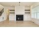 Living room with fireplace, built-ins, hardwood floors, and a view of the staircase at 108 Bearwallow Forest Way, Wendell, NC 27591