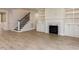 Spacious living room with fireplace, staircase, and built-in shelves at 108 Bearwallow Forest Way, Wendell, NC 27591