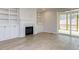 Bright living room with fireplace, built-in shelves, and sliding glass doors to deck at 108 Bearwallow Forest Way, Wendell, NC 27591