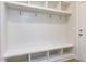 Mudroom entrance featuring a white bench with storage and hooks for hanging at 108 Bearwallow Forest Way, Wendell, NC 27591