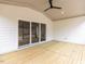 Covered porch featuring wood floors and ceiling fan with an entrance to the back yard at 108 Bearwallow Forest Way, Wendell, NC 27591