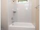 Modern shower and tub combo featuring white subway tile, recessed shelf, and chrome fixtures at 108 Bearwallow Forest Way, Wendell, NC 27591