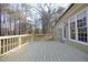 Large wooden back deck with railing that overlooks the surrounding yard and trees at 109 Springwood Dr, Wake Forest, NC 27587