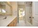 Well-lit bathroom features a vanity with marble countertop, and a tub with shower at 109 Springwood Dr, Wake Forest, NC 27587