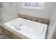 Oversized white soaking tub with jets and chrome faucet and fixtures at 109 Springwood Dr, Wake Forest, NC 27587