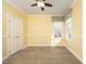 Cozy bedroom features a ceiling fan, sunny yellow walls, trim accents, and wood-look flooring at 109 Springwood Dr, Wake Forest, NC 27587