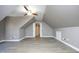 Spacious bonus room with vaulted ceilings, neutral walls, and wood-look flooring at 109 Springwood Dr, Wake Forest, NC 27587