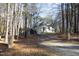 Gravel driveway leading to a charming light green house at 109 Springwood Dr, Wake Forest, NC 27587