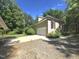 Exterior view showing the side of the house, a garage, and a lush yard with mature trees at 109 Springwood Dr, Wake Forest, NC 27587