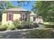 Charming home exterior features red shutters, a well-maintained lawn, and lovely landscaping at 109 Springwood Dr, Wake Forest, NC 27587
