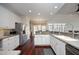 Bright kitchen with white cabinets, stainless steel appliances, and hardwood flooring at 109 Springwood Dr, Wake Forest, NC 27587