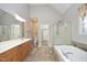 Spacious main bathroom with double vanity, soaking tub, and separate shower at 109 Springwood Dr, Wake Forest, NC 27587