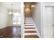 Elegant staircase leading to upper level with hardwood floors at 109 Springwood Dr, Wake Forest, NC 27587