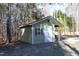 Exterior storage shed with white doors and shutters at 109 Springwood Dr, Wake Forest, NC 27587