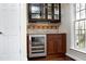 Wet bar with wine cooler and glass-front cabinets at 109 Springwood Dr, Wake Forest, NC 27587