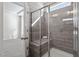 Shower with gray tile and built-in seat at 1226 Barn Cat Way, Apex, NC 27502