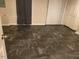 Spacious finished basement with dark gray tile flooring at 1235 Stone Manor Dr, Raleigh, NC 27610