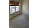 Bright bedroom with a window and neutral-toned carpet at 1235 Stone Manor Dr, Raleigh, NC 27610