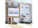Two-story townhome with stone and siding exterior, two-car garage, and landscaping at 1235 Stone Manor Dr, Raleigh, NC 27610