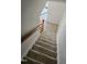 Carpeted staircase with wooden railing leading to the upper level at 1235 Stone Manor Dr, Raleigh, NC 27610