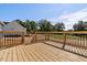 Wooden deck with black metal railings overlooking backyard at 1240 Dover St # 57, Roxboro, NC 27573