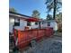 Cozy back deck featuring a bright red umbrella and painted wood railings, perfect for outdoor entertaining at 1309 Eastern Avenue Ave, Rocky Mount, NC 27801