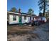 View of backyard featuring green grass, gravel and a back deck with outdoor seating at 1309 Eastern Avenue Ave, Rocky Mount, NC 27801