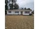 Charming single-story home with white siding, black shutters, a green door, and a spacious front yard at 1309 Eastern Avenue Ave, Rocky Mount, NC 27801