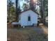 White vinyl-sided outbuilding with a single door, small window, and a simple wooden table outside at 1309 Eastern Avenue Ave, Rocky Mount, NC 27801