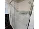 Full sized shower featuring glass door, safety handle, and built in shelving at 1309 Eastern Avenue Ave, Rocky Mount, NC 27801