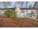 Rear view of house with mature trees in the background at 1405 Auman Rd, Raleigh, NC 27603