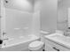 Bathroom with shower/tub combo, toilet and white vanity at 157 Rainbow Dr, Dunn, NC 28334