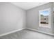Simple bedroom with grey carpet and one window at 157 Rainbow Dr, Dunn, NC 28334