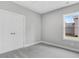Spacious bedroom with grey carpet, double doors, and a window at 157 Rainbow Dr, Dunn, NC 28334