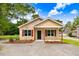 New construction home with tan siding, landscaping, and a covered porch at 157 Rainbow Dr, Dunn, NC 28334