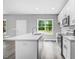 Open concept kitchen with white cabinets, quartz countertops, and an island at 157 Rainbow Dr, Dunn, NC 28334