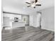 Open concept kitchen with island, white cabinets, and gray vinyl plank flooring at 157 Rainbow Dr, Dunn, NC 28334