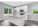 Modern kitchen with white cabinets, quartz countertops, and an island at 157 Rainbow Dr, Dunn, NC 28334