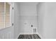 Laundry room with wood-look flooring, shelving and exterior door at 157 Rainbow Dr, Dunn, NC 28334