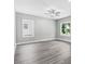 Bright living room featuring gray vinyl plank flooring and a ceiling fan at 157 Rainbow Dr, Dunn, NC 28334