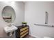 Modern powder room featuring a stylish vanity, round mirror, and grab bars for accessibility at 179 Deodora Ln, Cameron, NC 28326