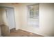 Simple bedroom with mirrored closet doors and a large window at 1924 Edgeleaf Dr, Willow Springs, NC 27592