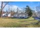 Gray house with a green lawn and trees at 205 Coachman Dr, Garner, NC 27529