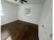 Bright bedroom with dark hardwood floors and ceiling fan at 222 Weston Rd, Garner, NC 27529