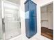 Bathroom boasts a walk-in shower, blue vanity, and linen closet at 2407 Hart Street # B, Durham, NC 27703