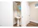 Small bathroom with pedestal sink and oval mirror at 2407 Hart Street # B, Durham, NC 27703