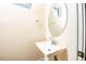 Small bathroom with pedestal sink and oval mirror at 2407 Hart Street # B, Durham, NC 27703